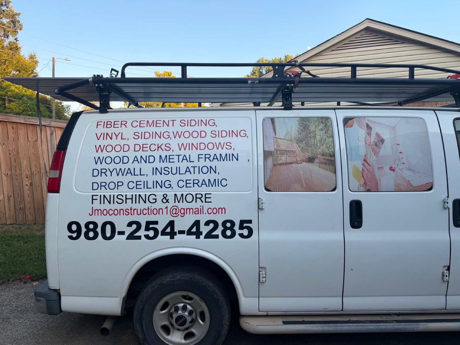 JMO Construction work van displaying remodeling services and contact information
